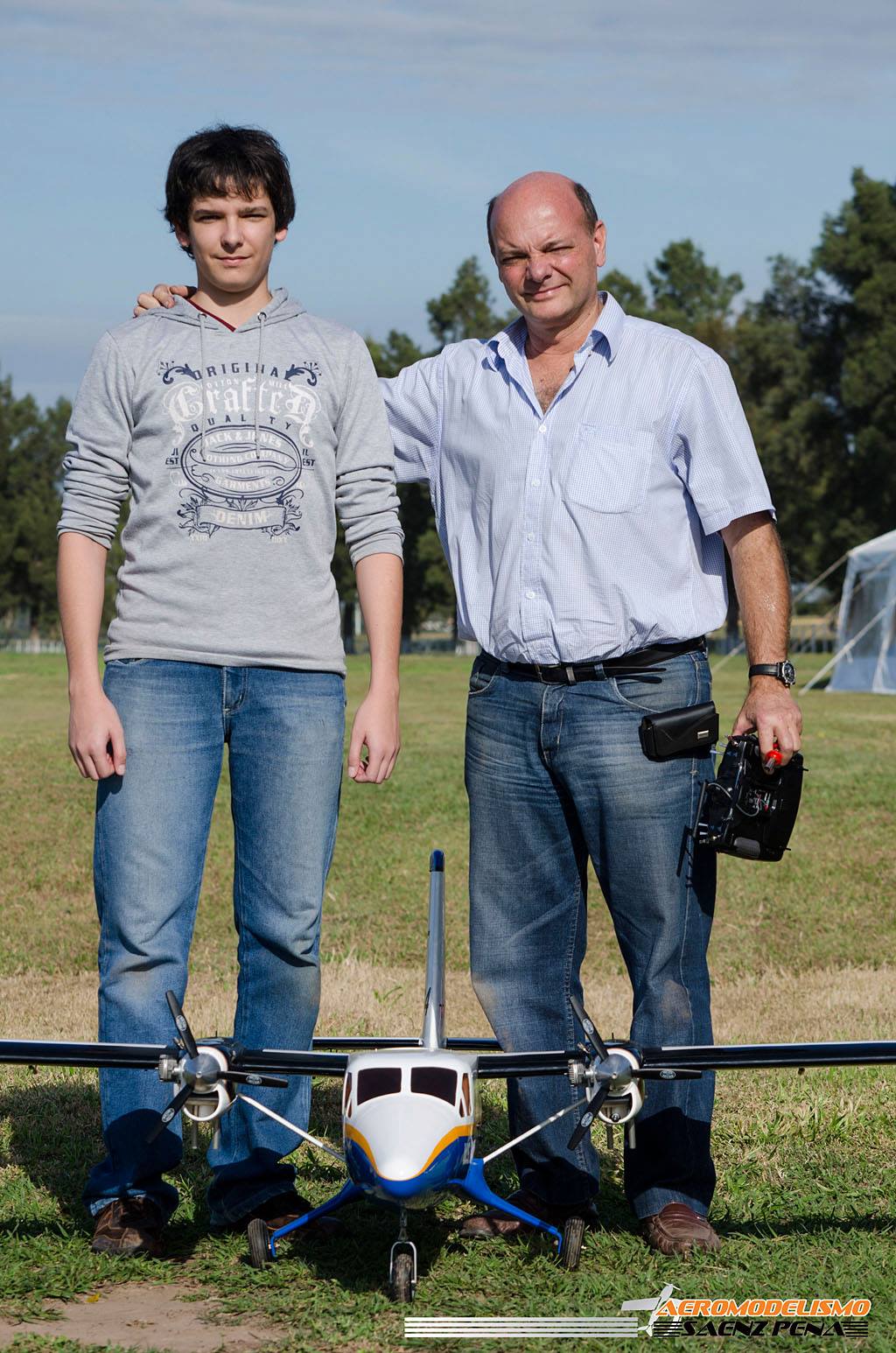 Two people standing together with a drone.